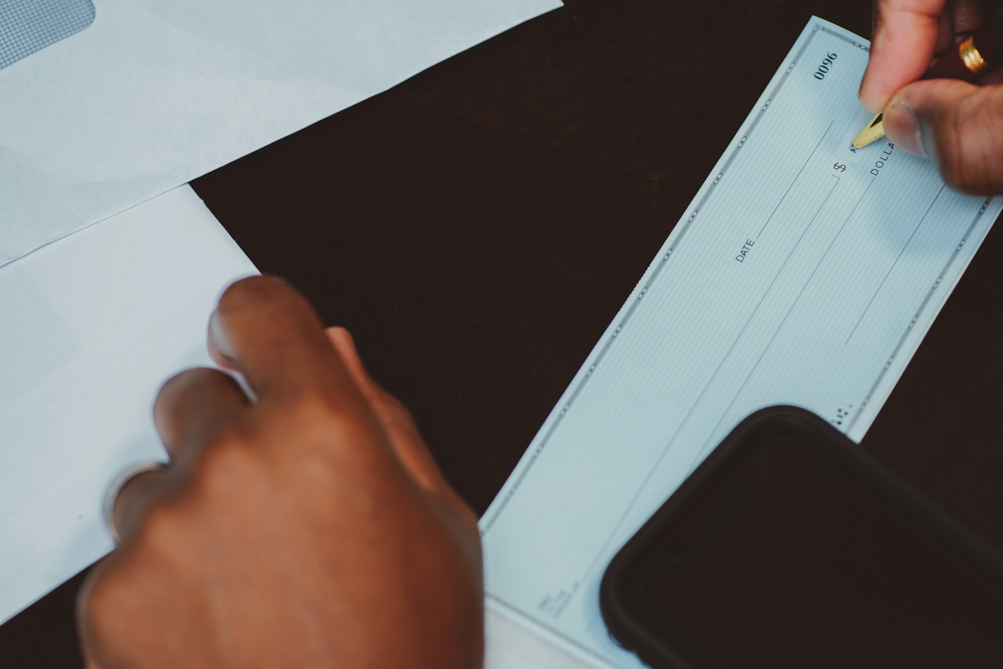 African American man writing out a check