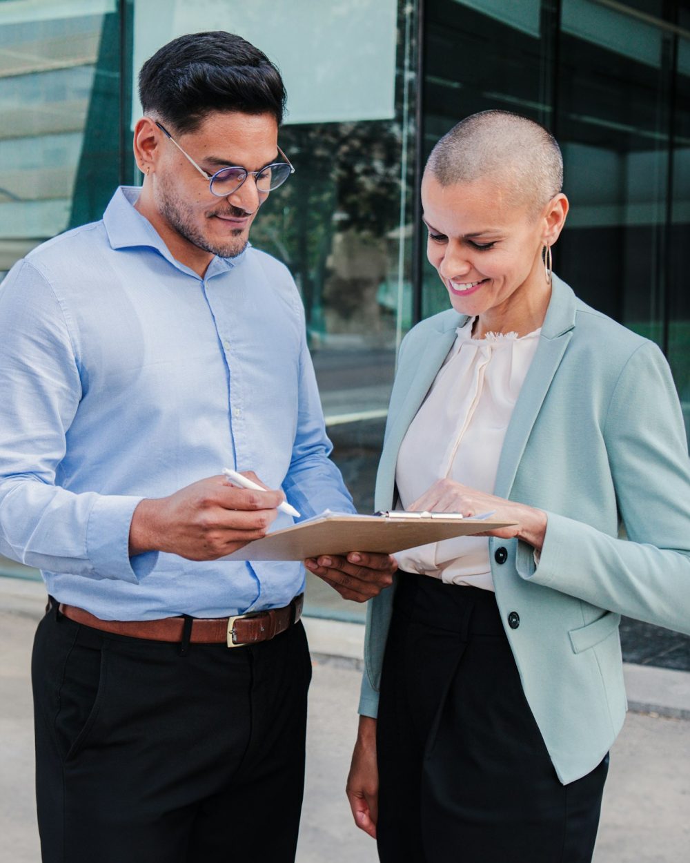 Vertical portrait of two business people working and cooperating together. Successful saleswoman